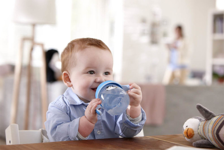 Teaching a child to drink from a mug