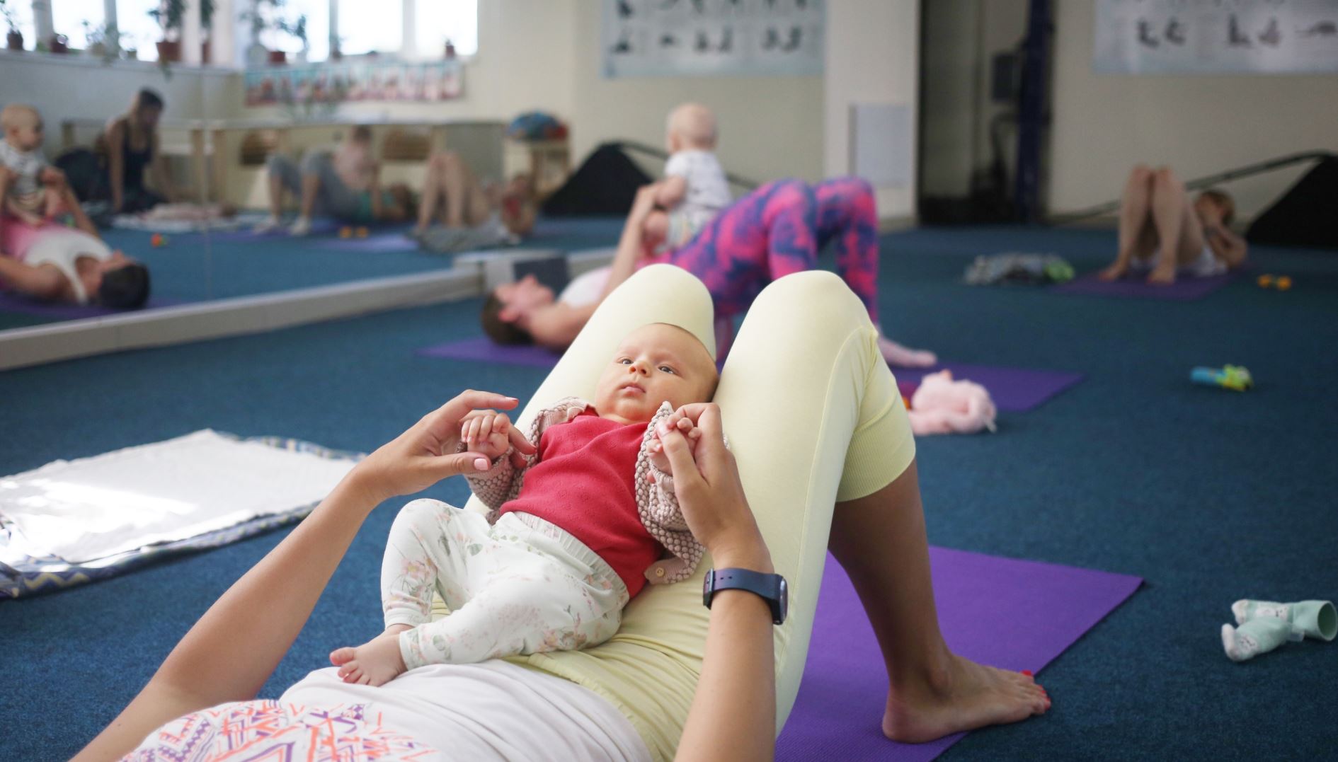 fitness with a baby in her arms